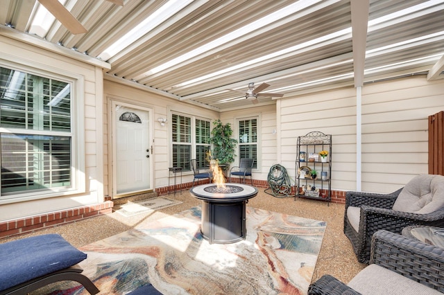 view of patio / terrace featuring ceiling fan and a fire pit