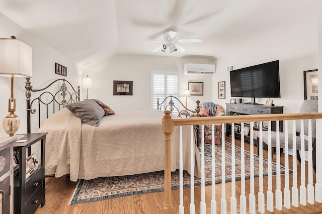 bedroom featuring hardwood / wood-style flooring and a wall unit AC