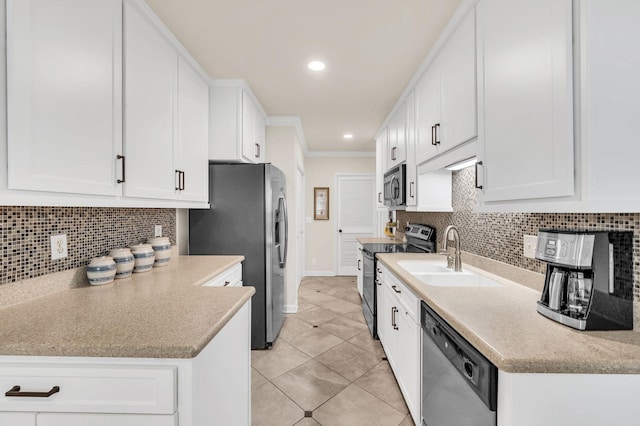 kitchen with stainless steel appliances, sink, white cabinets, and backsplash