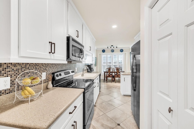 kitchen featuring sink, backsplash, stainless steel appliances, and white cabinets