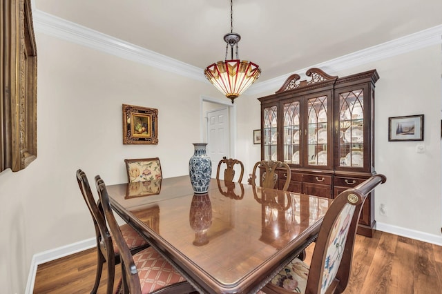 dining area with crown molding and dark hardwood / wood-style floors