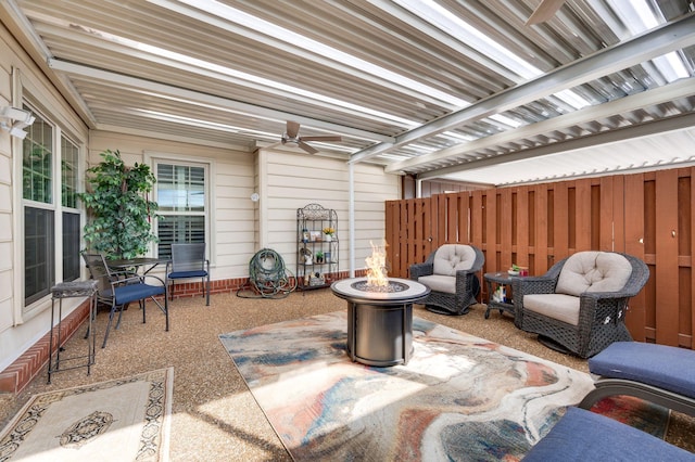 view of patio / terrace with ceiling fan and an outdoor fire pit