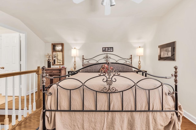 bedroom with wood-type flooring and lofted ceiling