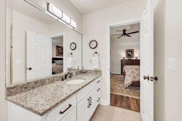 bathroom with vanity, hardwood / wood-style flooring, ornamental molding, and ceiling fan