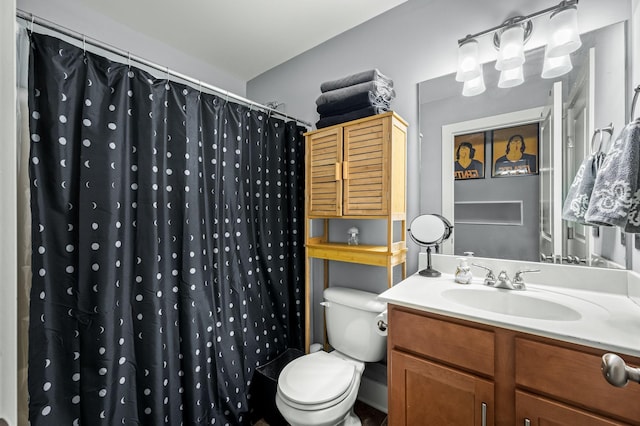 bathroom featuring vanity, a shower with shower curtain, and toilet