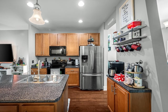 kitchen featuring decorative light fixtures, sink, dark wood-type flooring, and black appliances