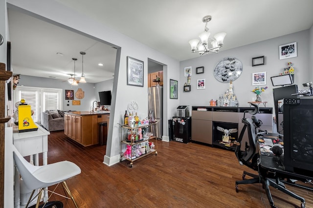 office area featuring dark hardwood / wood-style floors and ceiling fan with notable chandelier