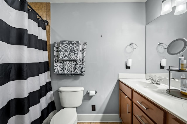 bathroom with vanity, curtained shower, and toilet