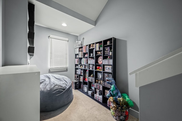 interior space with vaulted ceiling and carpet