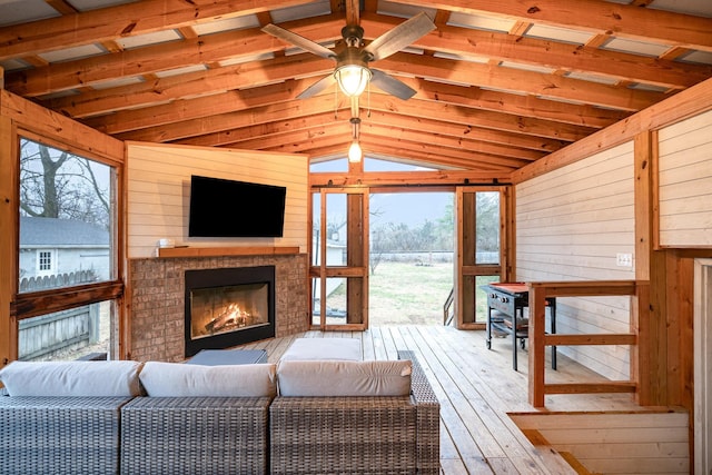 sunroom with ceiling fan and lofted ceiling with beams