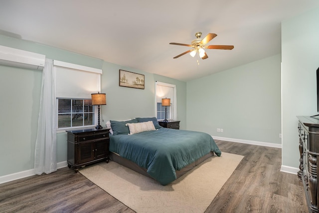 bedroom with wood-type flooring, an AC wall unit, and ceiling fan