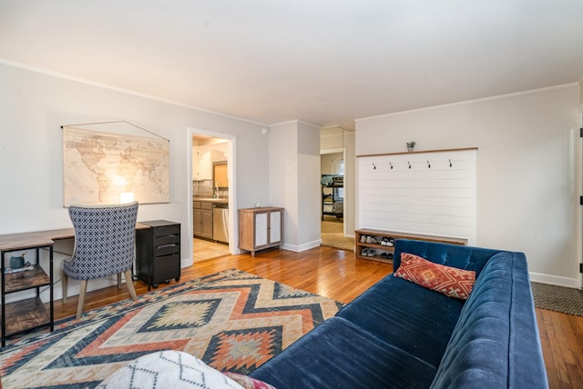 living room with ornamental molding and light wood-type flooring