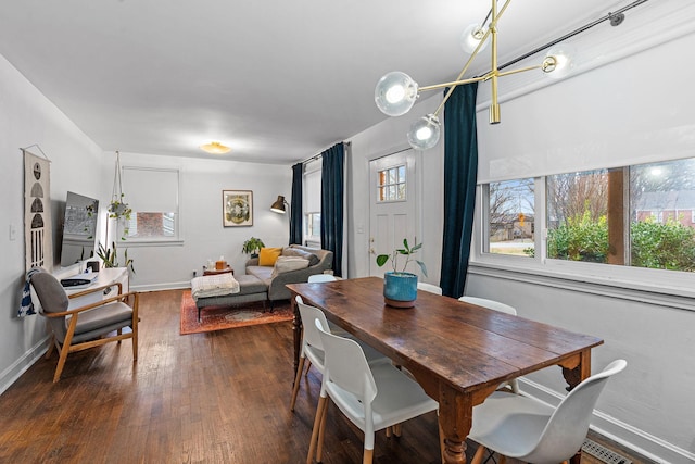 dining area featuring plenty of natural light and dark hardwood / wood-style floors