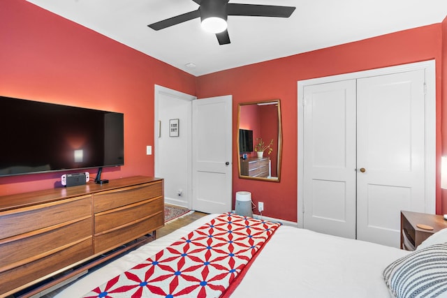 bedroom with ceiling fan and a closet