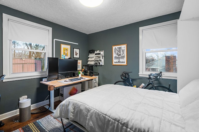 bedroom with hardwood / wood-style flooring and a textured ceiling