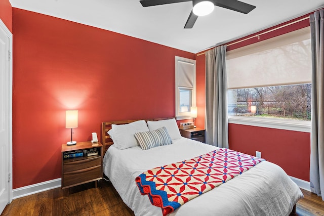 bedroom with ceiling fan and dark hardwood / wood-style flooring