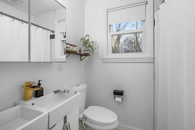 bathroom featuring toilet and a shower with shower curtain