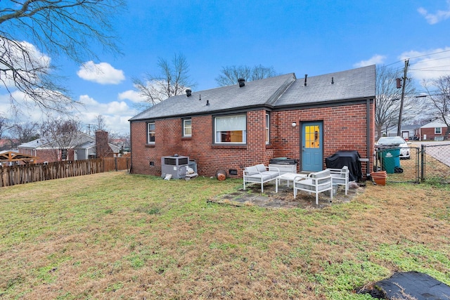 rear view of property featuring central AC and a yard