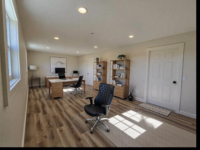 home office with light hardwood / wood-style floors