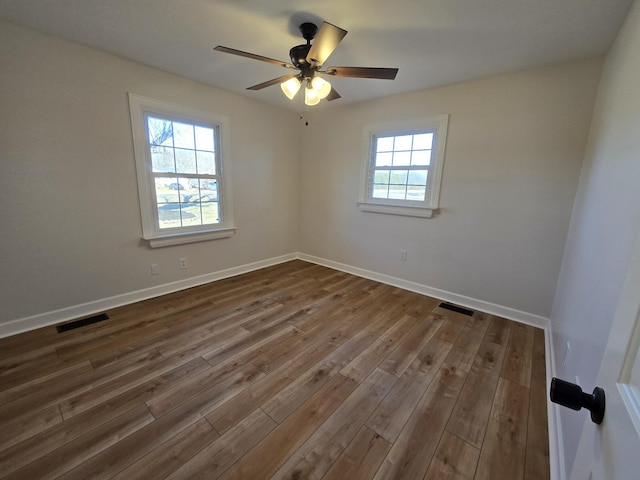 unfurnished room featuring dark hardwood / wood-style floors and ceiling fan