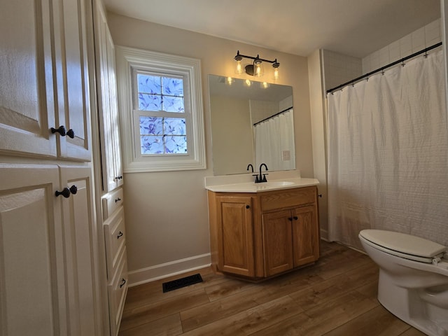 bathroom featuring vanity, toilet, and hardwood / wood-style floors