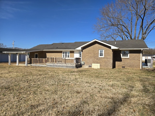 rear view of property featuring a wooden deck and a yard