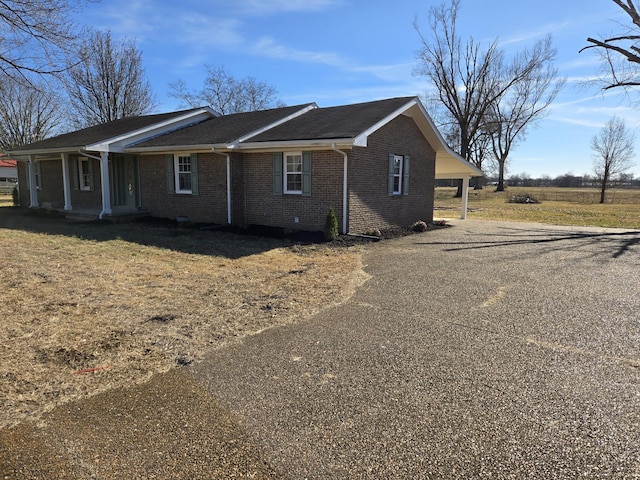 view of side of property featuring a carport