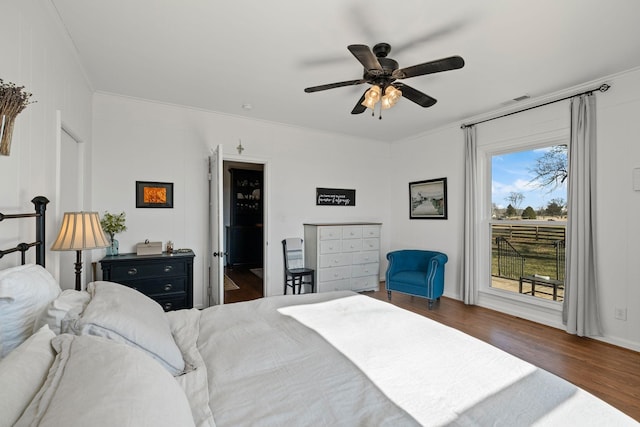 bedroom with crown molding, ceiling fan, access to exterior, and dark hardwood / wood-style flooring