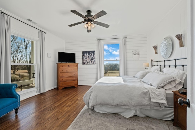 bedroom with dark hardwood / wood-style flooring and ceiling fan