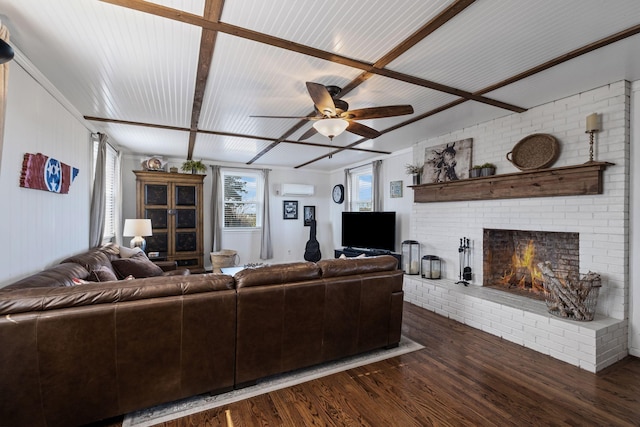 living room with ceiling fan, dark hardwood / wood-style floors, a wall mounted AC, and a brick fireplace