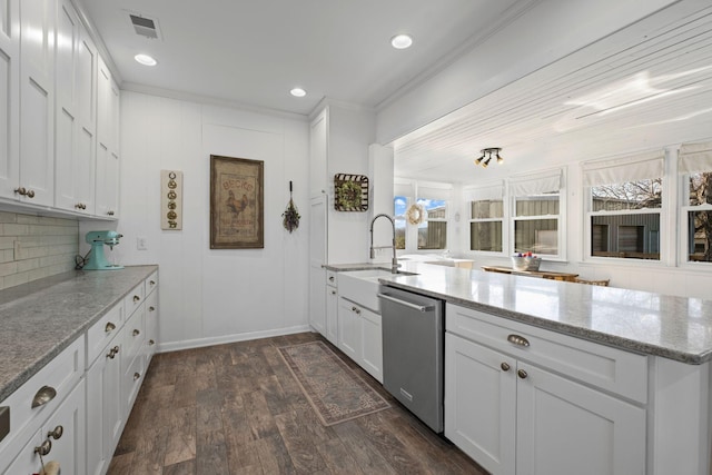 kitchen with dark wood-type flooring, white cabinetry, stainless steel dishwasher, light stone countertops, and decorative backsplash