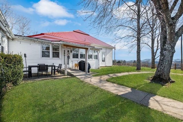 rear view of house featuring a yard