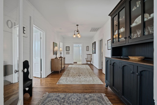 foyer with french doors, dark hardwood / wood-style floors, and a chandelier