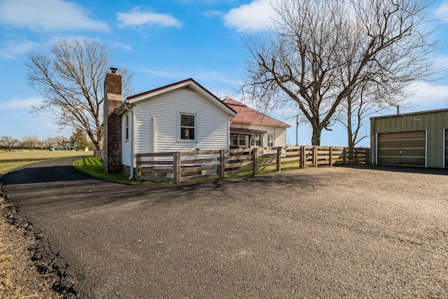 view of side of home with an outbuilding and a garage