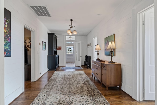 interior space featuring an inviting chandelier and dark hardwood / wood-style floors