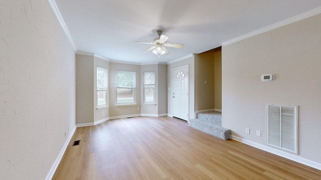 unfurnished room with crown molding, ceiling fan, and light hardwood / wood-style flooring