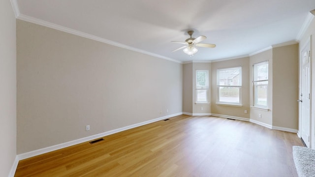 spare room featuring crown molding, ceiling fan, and light wood-type flooring