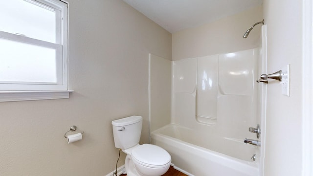 bathroom featuring toilet and shower / bath combination