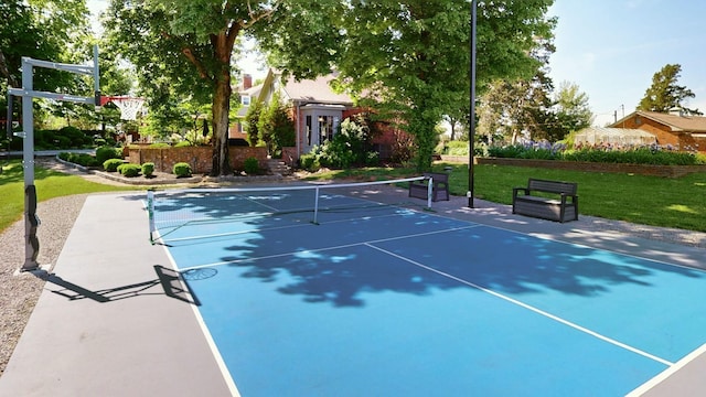 view of sport court with basketball court and a lawn