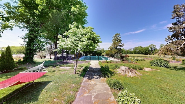 view of yard with a fenced in pool