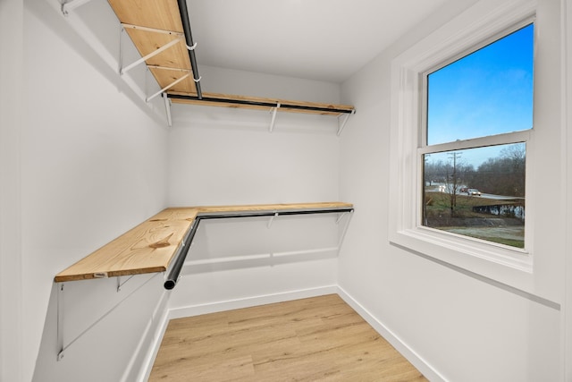 spacious closet featuring hardwood / wood-style floors