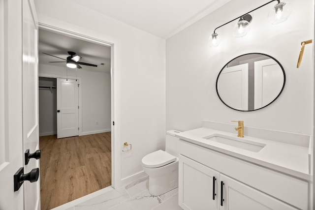 bathroom with vanity, ceiling fan, and toilet