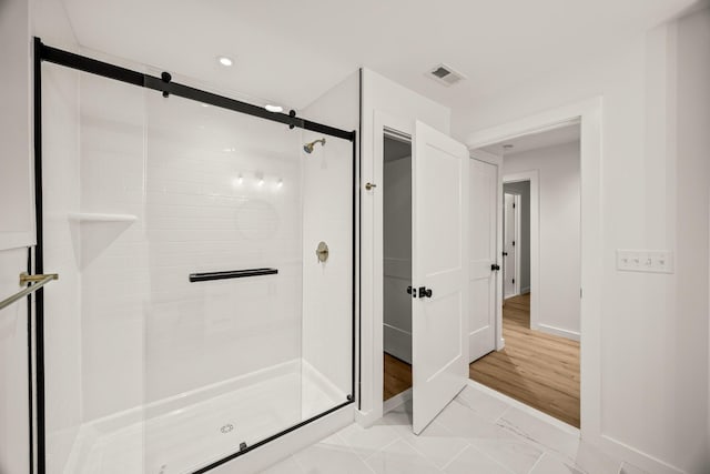 bathroom featuring a shower with shower door