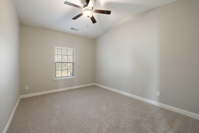 empty room featuring ceiling fan, lofted ceiling, and carpet floors