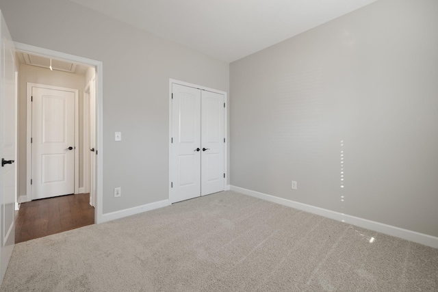 unfurnished bedroom with a closet and dark colored carpet