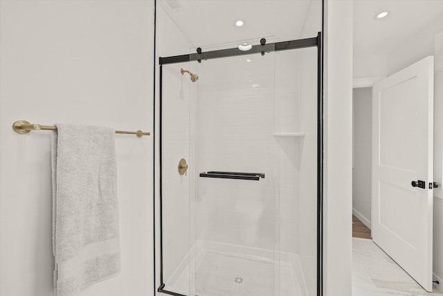 bathroom featuring a shower with shower door