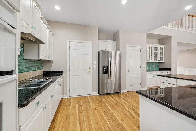 kitchen with white cabinetry, stainless steel refrigerator with ice dispenser, tasteful backsplash, light hardwood / wood-style floors, and electric stovetop