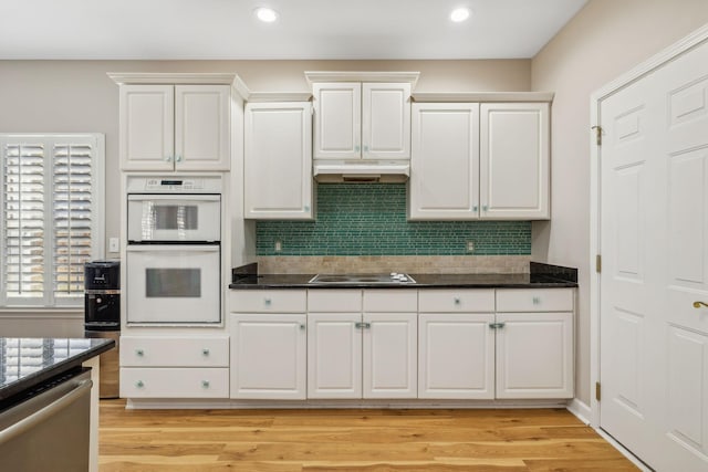 kitchen with white cabinetry, light hardwood / wood-style flooring, stainless steel dishwasher, white double oven, and electric stovetop