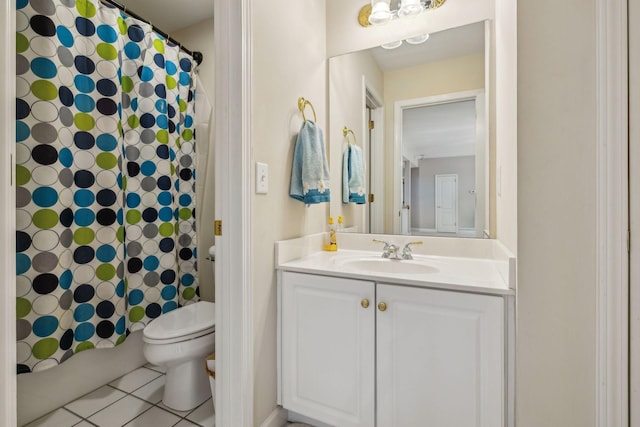 bathroom featuring tile patterned flooring, vanity, and toilet