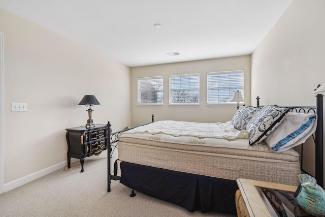 bedroom featuring light colored carpet